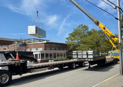 Crane Putting Unit On Building Next To Truck