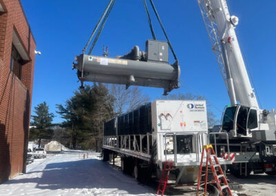Unit Being Lifted By Crane Outside In Snow