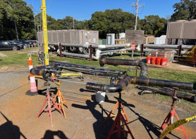 Units And Piping In Yard With Trees